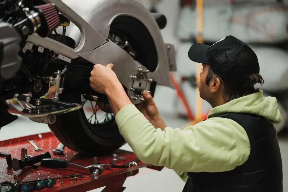 Mechanic working on a motorcycle.