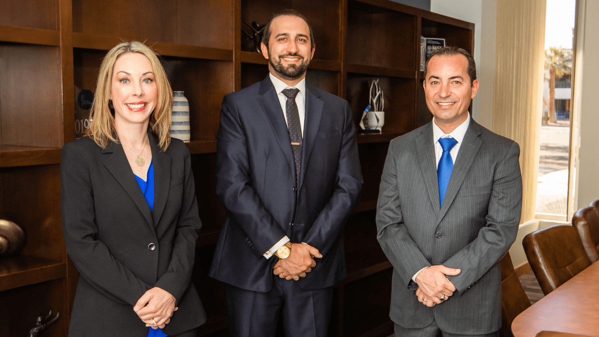 Kristina Kirigin, Joe Riccio and Boris Avramski of Marathon Law Group standing in the conference room.