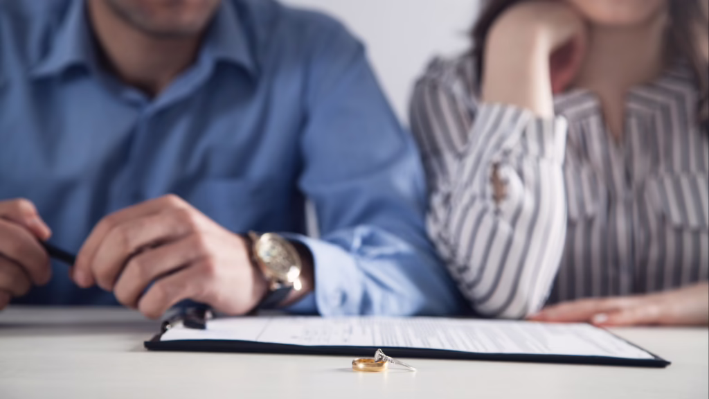 What Happens to a Business in a Nevada Divorce? 1 A man and woman sit near divorce papers and wedding rings on a table, symbolizing the end of a marriage. © Marathon Law Group