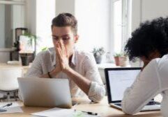 Law professionals concentrating on legal research with laptops at office desk, collaborating on law cases and analysis, providing quality legal services in a professional environment. © Marathon Law Group