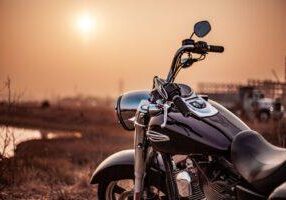 Motorcycle parked outdoors in sunset, showcasing road safety law compliance, traffic law awareness, and legal requirements for riding, promoting motorcycle safety and legal guidelines. © Marathon Law Group